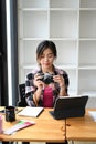 Female photographer checking pictures previews on camera. Royalty Free Stock Photo