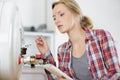 Portrait female plumber working on central heating boiler Royalty Free Stock Photo