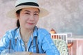 Portrait of female protrait in white hat and looking away.