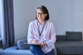 Portrait of female psychologist with clipboard sitting in office Royalty Free Stock Photo