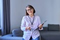 Portrait of female psychologist with clipboard sitting in office Royalty Free Stock Photo