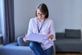 Portrait of female psychologist with clipboard sitting in office Royalty Free Stock Photo