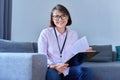 Portrait of female psychologist sitting on sofa in office