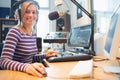 Portrait of female radio host using computer in studio Royalty Free Stock Photo