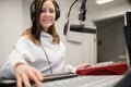 Radio Jockey Smiling While Wearing Headphones In Studio Royalty Free Stock Photo