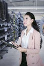 Female shopkeeper making goods list