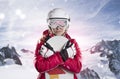 Portrait of a female snowboarder back against sunlight in mountains panorama