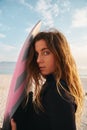 Portrait Of Female Surfer At The Beach With Surf Board Or Kite Surfing Wearing Wetsuit Royalty Free Stock Photo