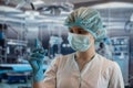 Portrait of female surgeon or assistant wearing surgical mask in operating theatre room Royalty Free Stock Photo