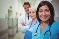 Portrait of female surgeon and doctors standing in corridor Royalty Free Stock Photo