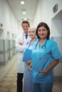 Portrait of female surgeon and doctors standing in corridor Royalty Free Stock Photo