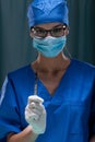 Portrait of a female surgeon holding surgical scalpel