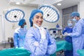 Portrait of female surgeon standing in operating room, ready to work on a patient. Woman medical worker surgical uniform in Royalty Free Stock Photo