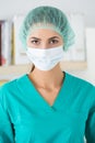 Portrait of female surgeon wearing protective mask and cup Royalty Free Stock Photo