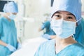 Portrait of female surgeon wearing surgical mask in the operating room, close-up Royalty Free Stock Photo