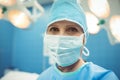 Portrait of female surgeon wearing surgical mask in operation theater Royalty Free Stock Photo