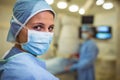 Portrait of female surgeon wearing surgical mask in operation theater Royalty Free Stock Photo