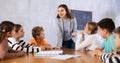 Portrait of female teacher giving lesson to children in school class Royalty Free Stock Photo