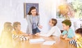 Portrait of female teacher giving lesson to children in school class Royalty Free Stock Photo