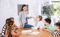 Portrait of female teacher giving lesson to children in school class Royalty Free Stock Photo