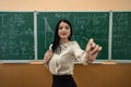 portrait female teacher or a student against blackboard and explain a lesson Royalty Free Stock Photo