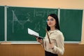 portrait female teacher or a student against blackboard and explain a lesson Royalty Free Stock Photo