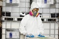 Portrait of female technician in hazmat suit and gas mask