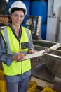 Portrait of female technician writing in clipboard Royalty Free Stock Photo