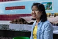 Portrait of a female thanaka seller at a buddhist temple. Thanaka paste on her face used as cosmetic and mosquito repellent.