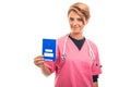 Portrait of female vet holding blue european health insurance ca