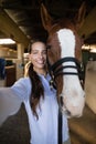 Portrait of female vet standing by horse Royalty Free Stock Photo