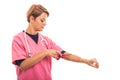 Portrait of female vet wearing pink scrub putting red tourniquet