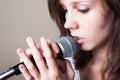 Portrait of female vocalist on gray background closeup Royalty Free Stock Photo