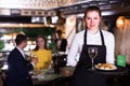 Portrait of female waiter who is holding tray with order Royalty Free Stock Photo