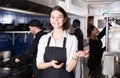 Portrait of female waiter who is standing with order on kitchen Royalty Free Stock Photo