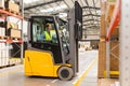 Female warehouse worker driving forklift. Warehouse worker preparing products for shipmennt, delivery, checking stock in Royalty Free Stock Photo