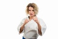 Portrait of female wearing martial arts uniform showing fists