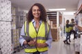 Portrait Of Female Worker Inside Busy Warehouse Checking Stock On Shelves Using Digital Tablet Royalty Free Stock Photo