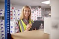 Portrait Of Female Worker In Logistics Distribution Warehouse Using Digital Tablet Royalty Free Stock Photo