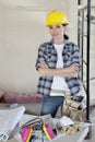 Portrait of female worker standing with arms crossed at construction site Royalty Free Stock Photo