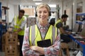 Portrait Of Female Worker Using Headset In Distribution Warehouse With Digital Tablet Royalty Free Stock Photo