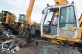 Portrait female worker wearing yellow helmet using crane Royalty Free Stock Photo