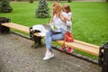 Little girl hugging her mother in city park Royalty Free Stock Photo