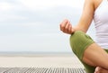 Portrait of female yoga hands at the beach