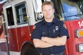 Portrait of a firefighter by a fire engine