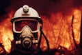 Portrait of a firefighter in a protective mask standing in the middle of a fire