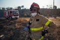 In this portrait a firefighter is seen working to extinguish several wildfires in the Catalonia region, where numerous wildfires