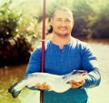 Portrait of fisherman with rod and fish