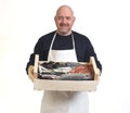 Portrait of a fishmonger with a box with seafood on white background Royalty Free Stock Photo