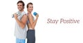 Portrait of a fit couple exercising with dumbbell Royalty Free Stock Photo